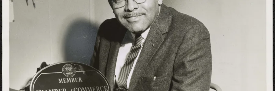 Fred Alexander holding an award from the Chamber of Commerce