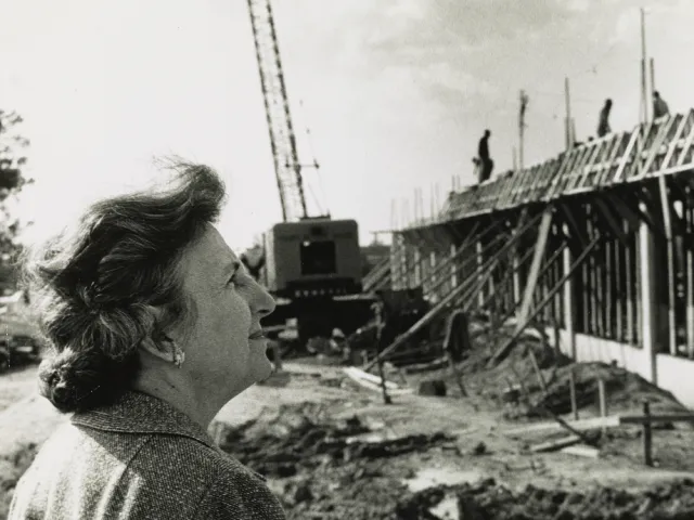 Bonnie Cone looking at the Library Building under construction in 1963.