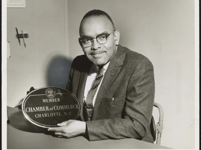 Fred Alexander holding an award from the Chamber of Commerce